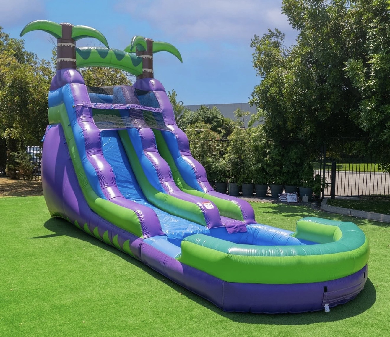 Tropical purple and green inflatable water slide with splash pool